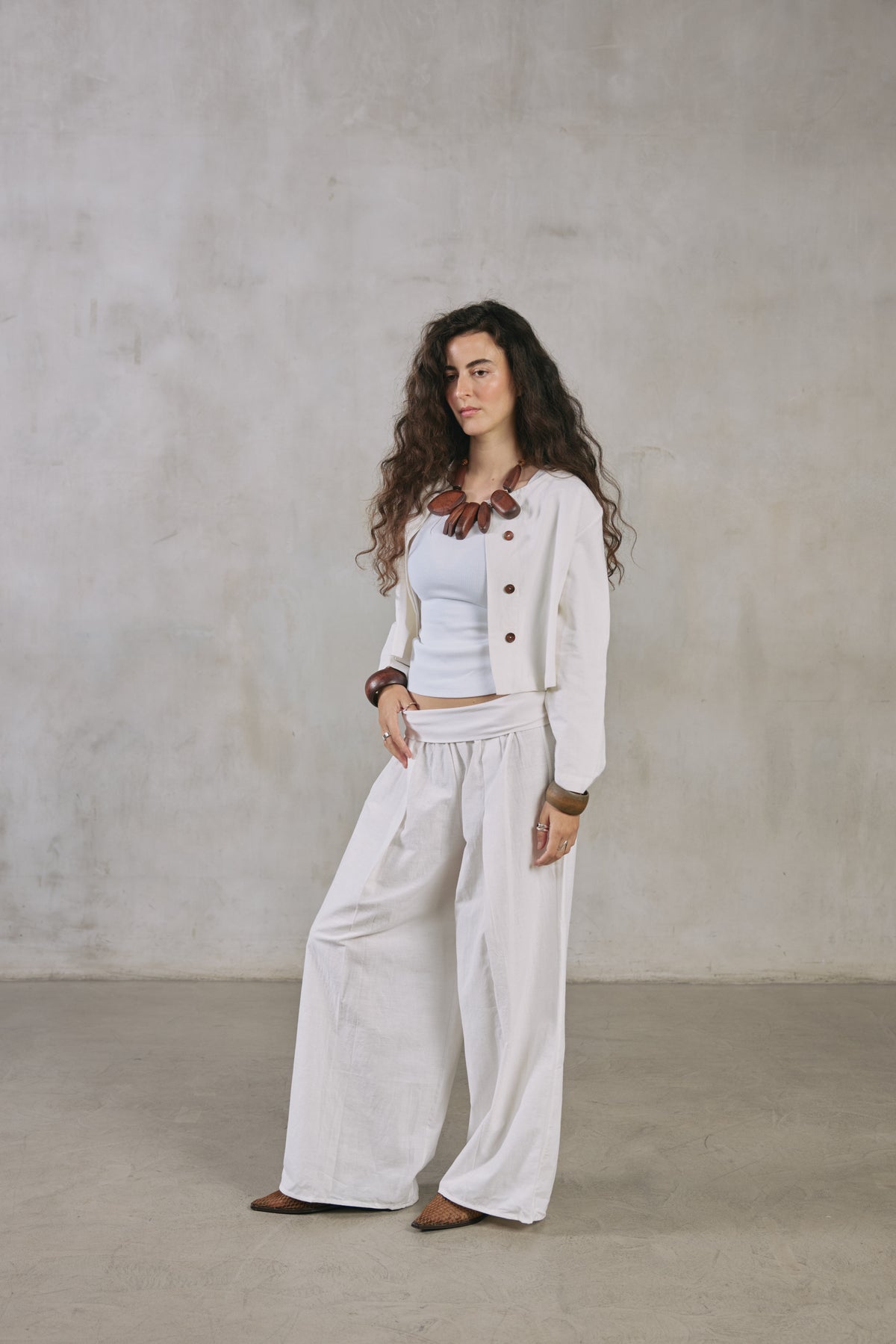 Front view of the ecru Lata cardigan over ecru Khadi pants